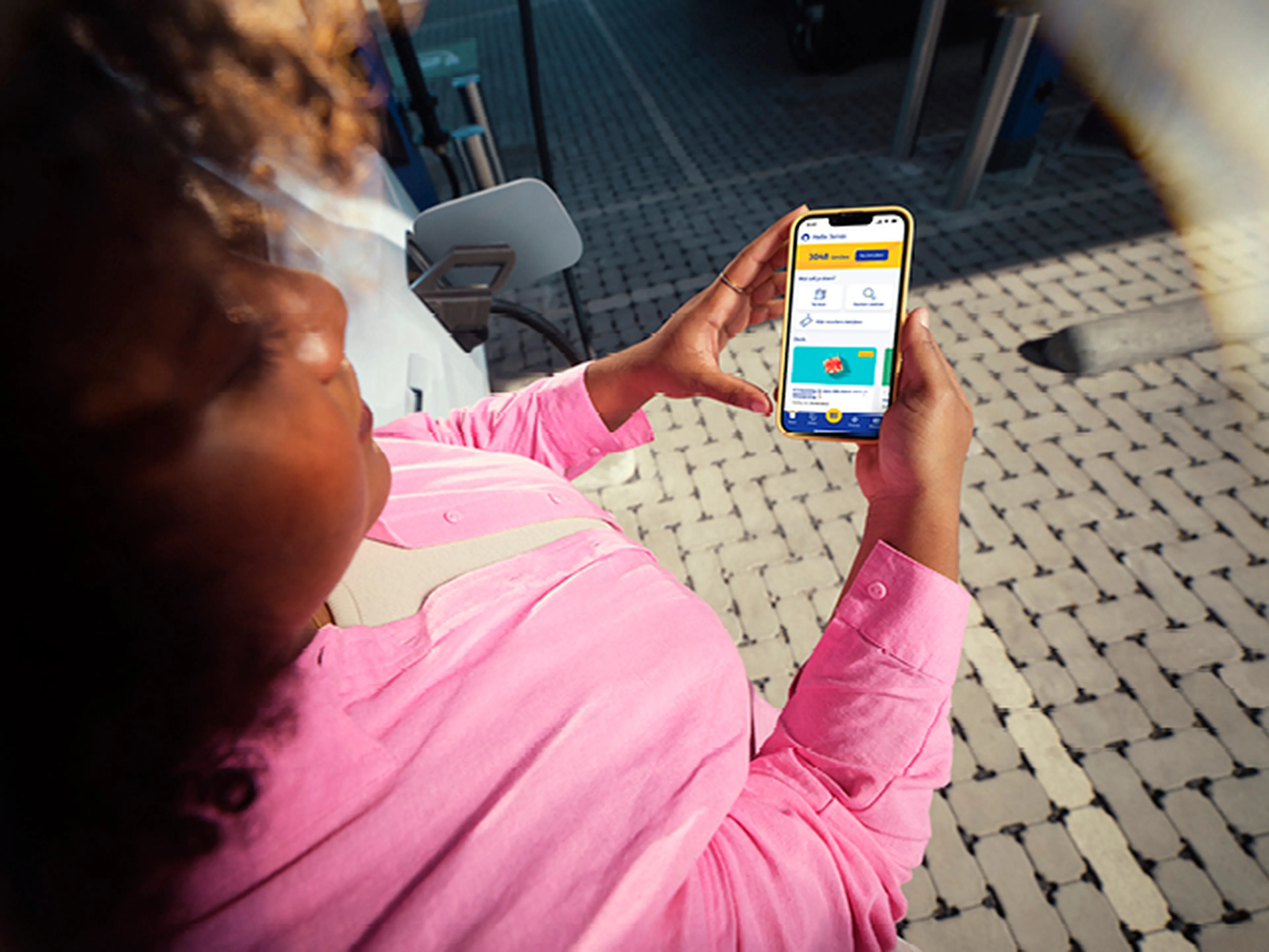 woman looks at the q8 electric business app