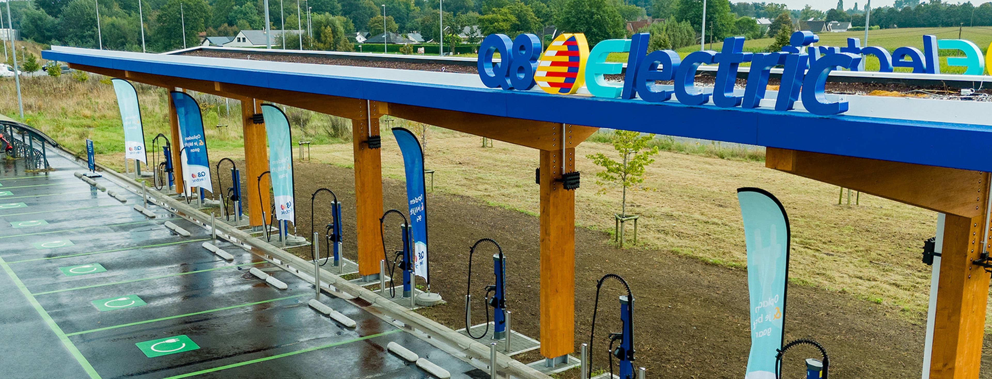 Q8 electric fast-charging station in Aalter with canopy, multiple chargers, and designated parking spots for electric vehicles.