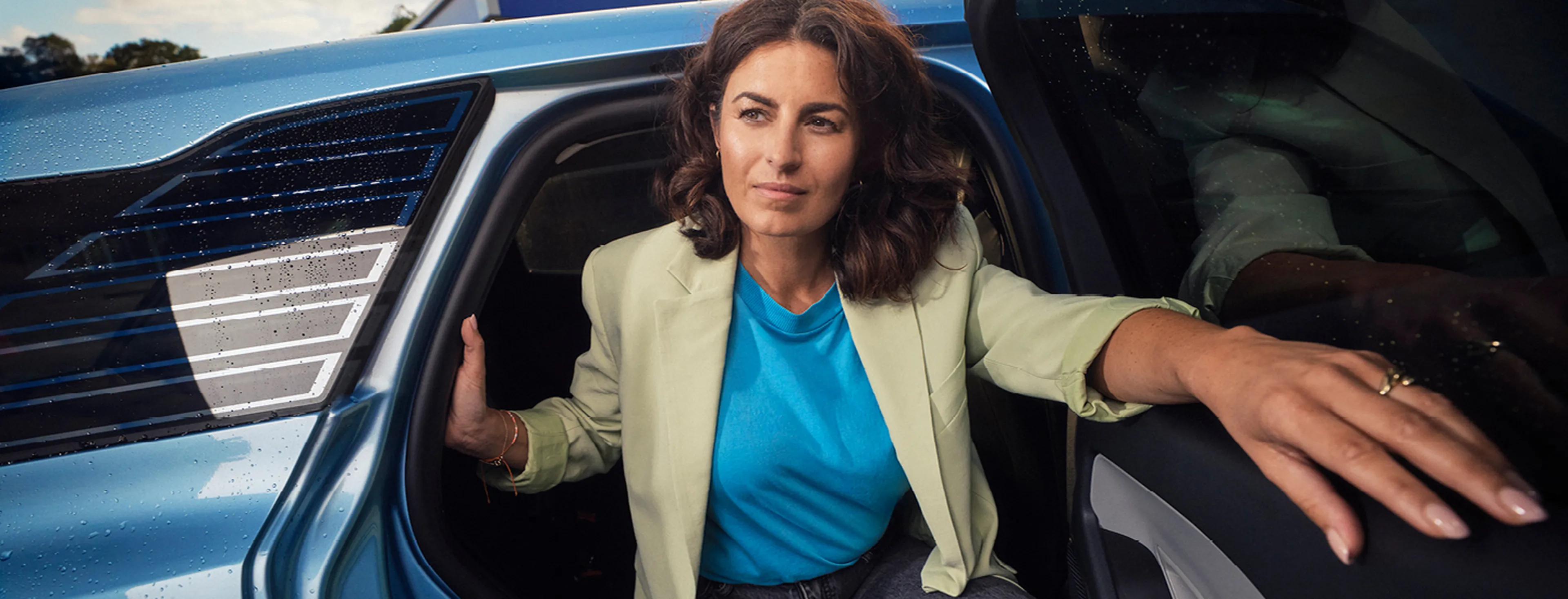 Femme sort de la voiture bleue chez Q8